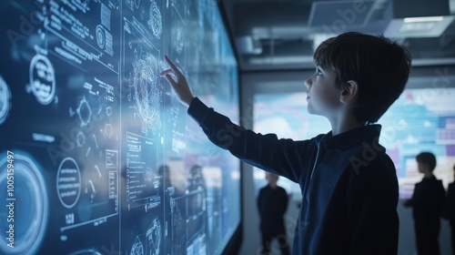 A boy pointing at a computer screen with a drawing of a brain
