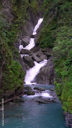 Cascading waterfall into Solomon Gulch with birds flying near Valdez, Alaska landscape photo