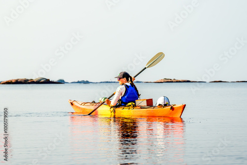 young woman paddling on a multiday sea kayak expedition on  georgian bay ontario  room for text photo