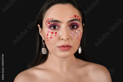 Pretty young woman with beautiful makeup on black background. Valentine's Day celebration