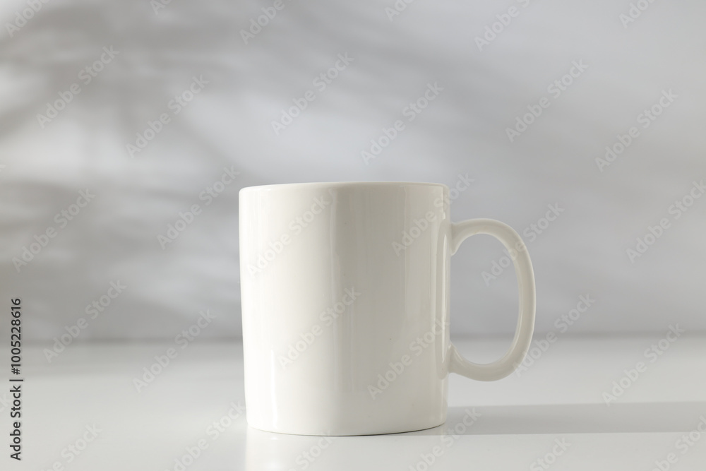 Obraz premium White classic cup on a light background