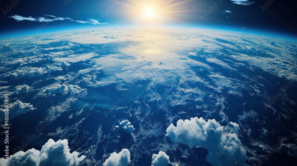 Earth from orbit, showing its vibrant blue and green surface beneath a blanket of white clouds, illuminated by sunlight Earth from orbit, showing its vibrant blue and green surface beneath a blanket of white clouds, illuminated by sunlight