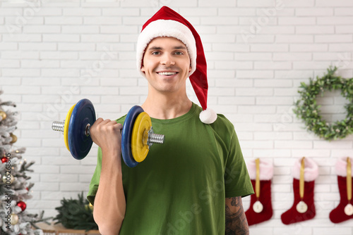 Smiling young man in santa ...