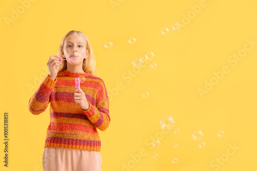 Happy teenager girl blowing...