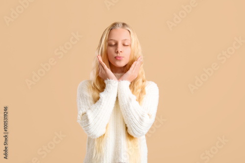 Happy teenager girl blowing...