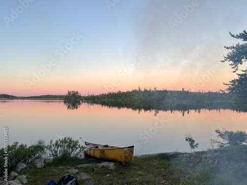 Canoe on Lake with Sunset Reflecting on Water