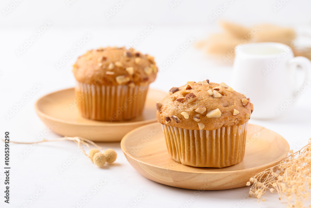 Vanilla almond muffin on wooden plate with white background Vanilla almond muffin on wooden plate with white background