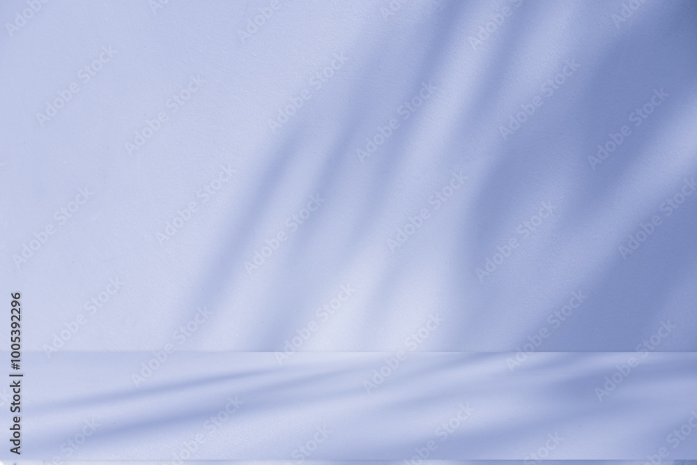 Obraz premium Studio style background wall decoration presentation uses white and blue tones. with shadows cast from a nearby window, concept creating a decorative backdrop.