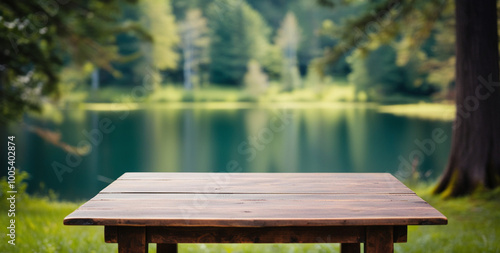 Fototapeta Naklejka Na Ścianę i Meble -  A rustic wooden table overlooks a serene lake and forest.