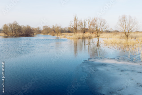 The spring ice is melting on the river. Spring flood, river with ice remnants, melting ice, river view, unreliable ice, spring