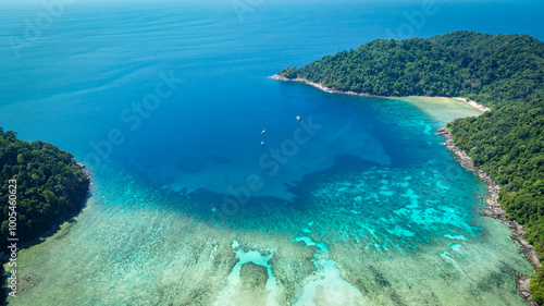 The aerial view of white sand beach tropical with seashore as the island in a coral reef ,blue and turquoise sea Amazing nature landscape with blue lagoon