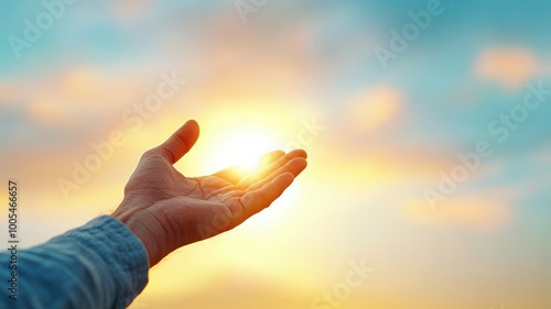 Hand Reaching for the Sky at Sunset