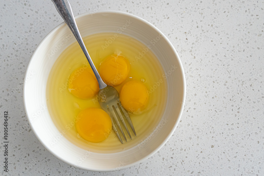 Egg yolks in white bowl ready to mix Egg yolks in white bowl ready to mix