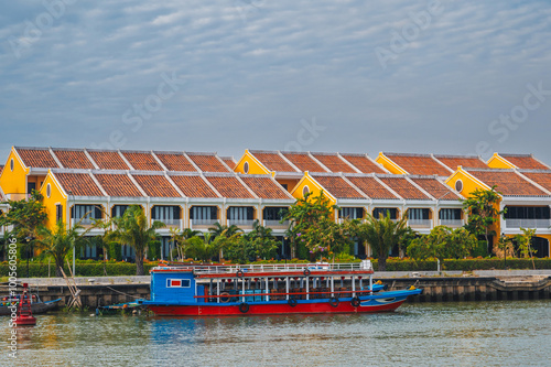 landscape with the Thu bon river and a boat in the old town in Hoi An in Vietnam during the day photo