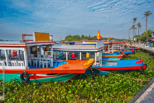 Traditional wooden Vietnamese boats on the Thu bon river in the old town in Hoi An in Vietnam in summer photo