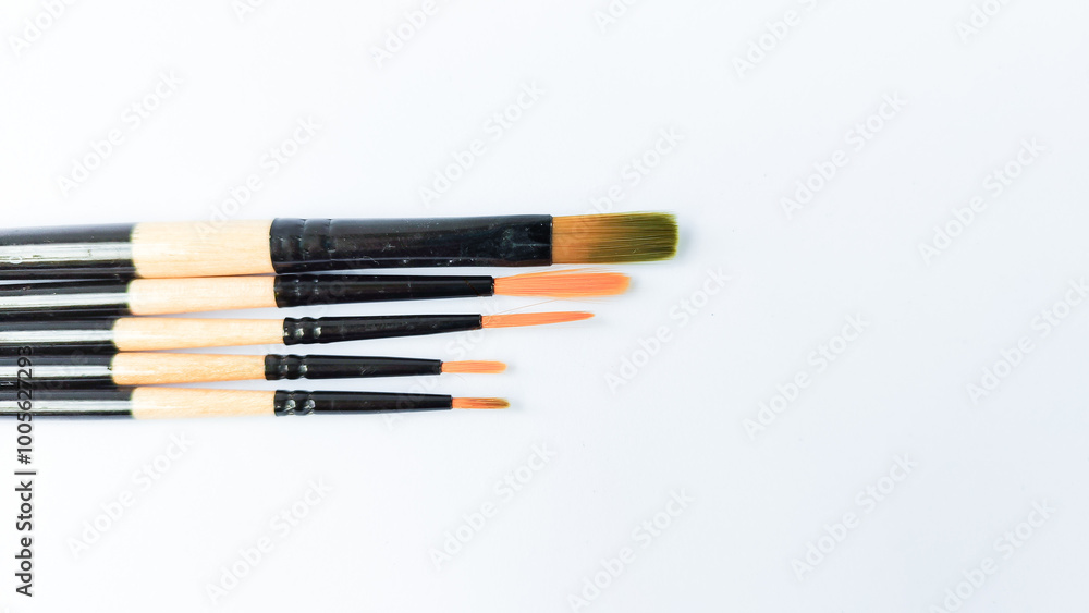 Different brushes with paints on white background Different brushes with paints on white background