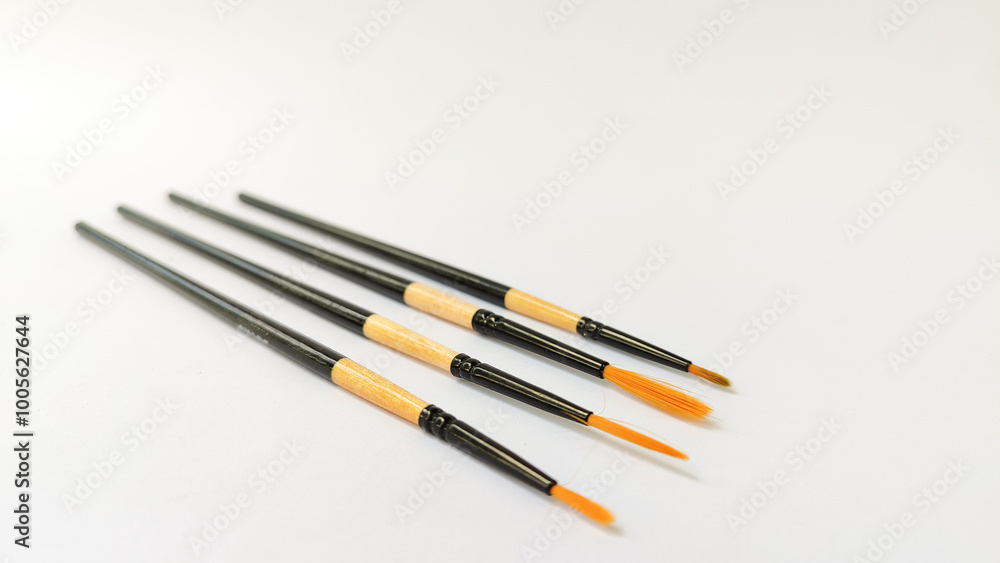 Different brushes with paints on white background Different brushes with paints on white background