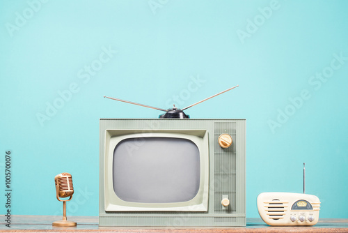 Golden microphone, retro TV and old radio front mint blue background. Vintage style filtered photo photo