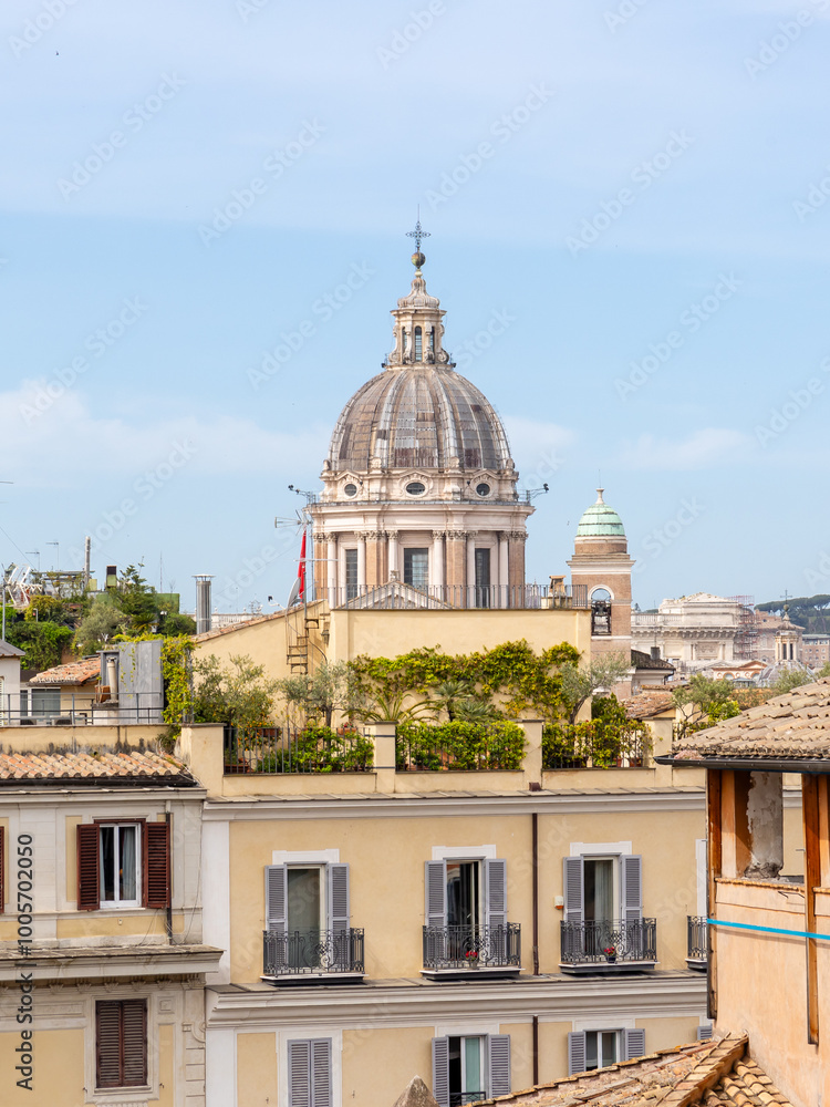 Obraz premium Rome, Italy - April 11, 2024: Rome, Italy - April 11, 2024: Rooftops and houses of the city of Rome, Italy