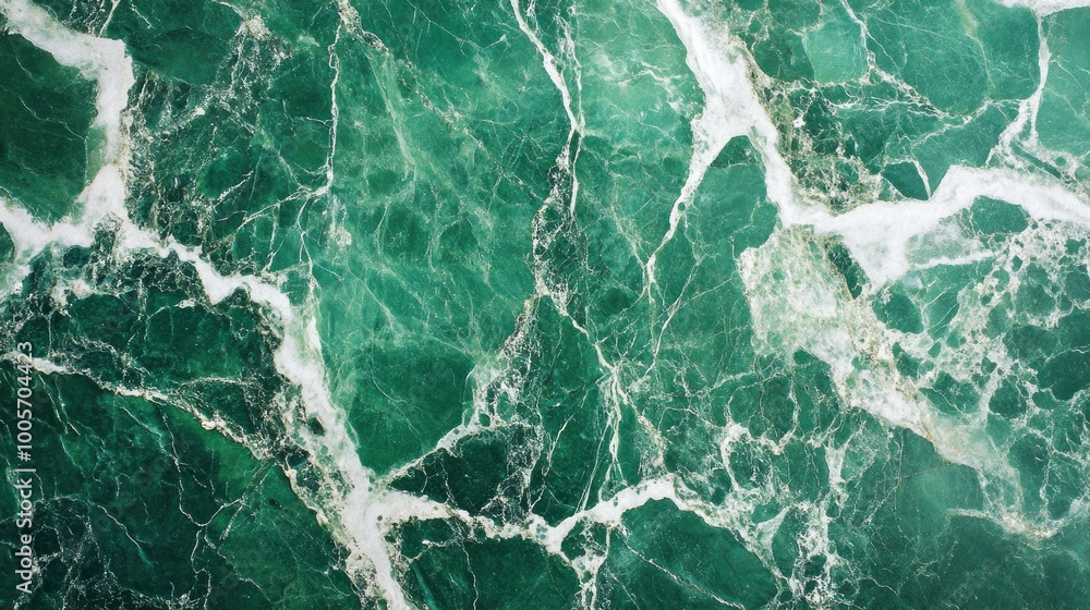 Obraz premium A close-up of green marble with white veining, showcasing natural patterns and textures.