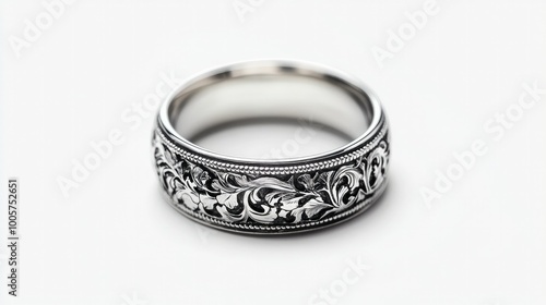 A detailed view of a silver ring with beautiful engravings, isolated on a clean white background, highlighting the skill and precision in its craftsmanship.