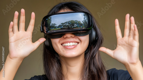 young woman is enjoying virtual reality experience, smiling with her hands raised in excitement. immersive technology captivates her attention