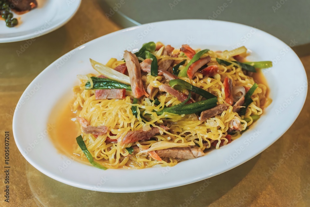 Wantan noodles, a Cantonese Chinese cuisine served dry with soy sauce and roast pork Wantan noodles, a Cantonese Chinese cuisine served dry with soy sauce and roast pork