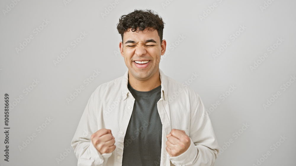 Happy man celebrating success with clenched fists against a white isolated background. Happy man celebrating success with clenched fists against a white isolated background.