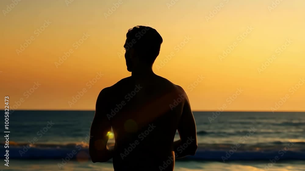 Silhouette of a man in contemplation against a vibrant beach sunset Silhouette of a man in contemplation against a vibrant beach sunset