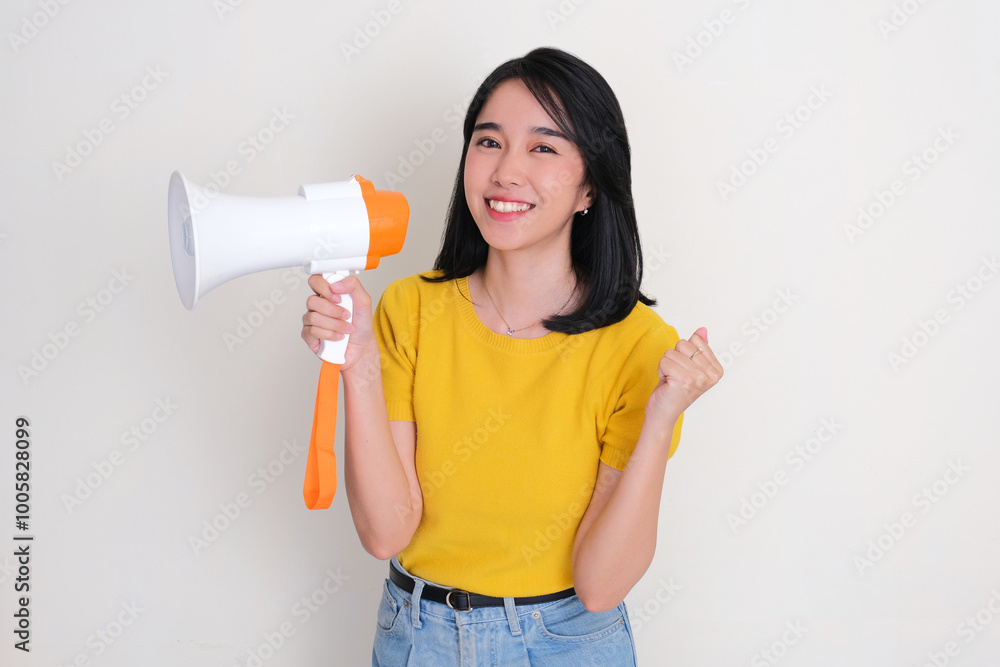 A woman showing happy expression while holding megaphone A woman showing happy expression while holding megaphone