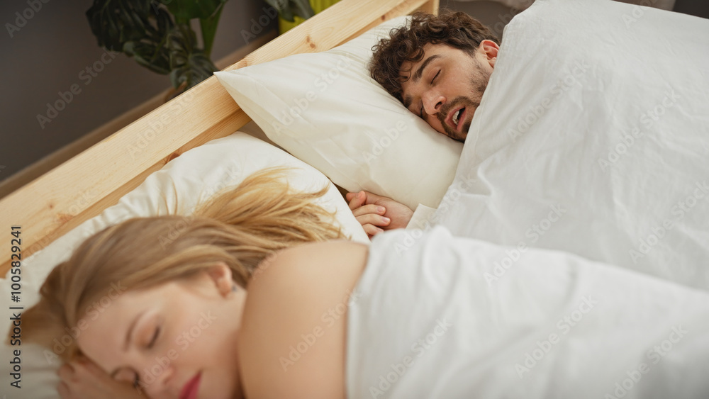 A man and woman, depicted as a loving couple, peacefully sleeping together in a cozy bedroom at home. A man and woman, depicted as a loving couple, peacefully sleeping together in a cozy bedroom at home.