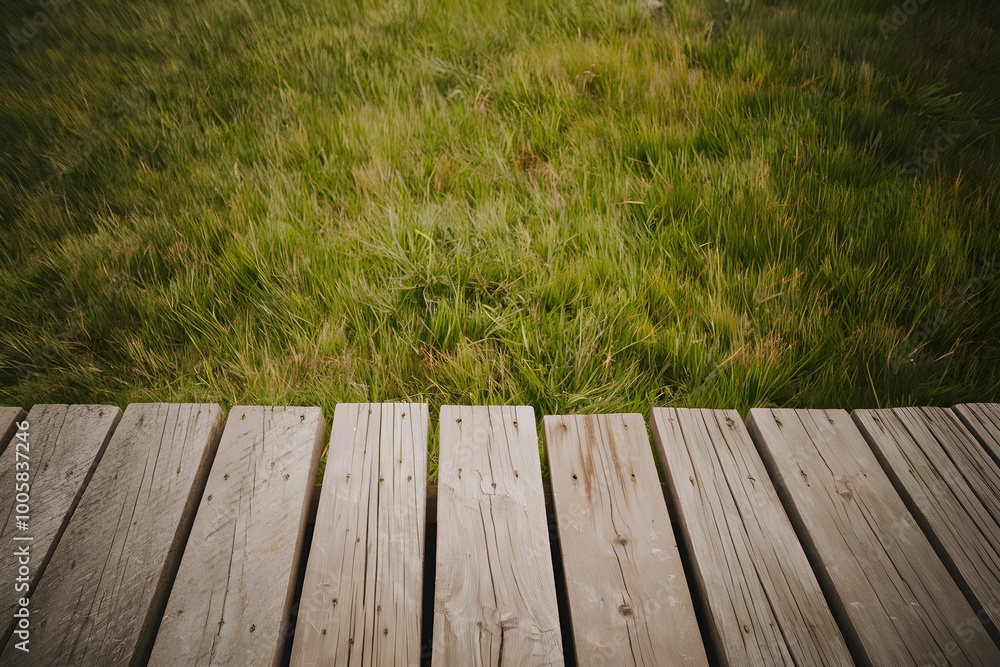 Wooden platform against green grassy field, serene and rustic outdoor setting Wooden platform against green grassy field, serene and rustic outdoor setting