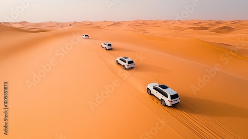 A convoy of white SUVs traverses a vast, sandy desert under a clear sky, showcasing adventure and exploration in nature.