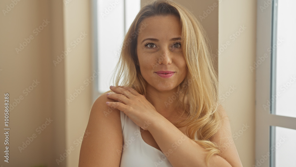 Portrait of a beautiful caucasian blonde woman indoors at home, exuding charm and elegance. Portrait of a beautiful caucasian blonde woman indoors at home, exuding charm and elegance.
