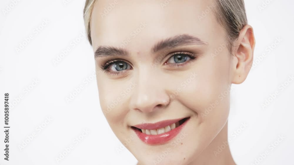 A beautiful model with flawless, fresh skin stands against a white background. This image highlights the significance of skincare and showcases a concept for cosmetic advertising. A beautiful model with flawless, fresh skin stands against a white background. This image highlights the significance of skincare and showcases a concept for cosmetic advertising.