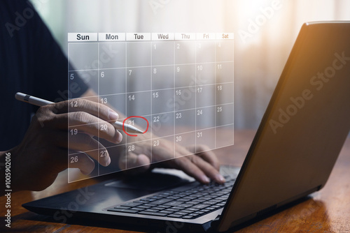 Businessman points pen at virtual table Appointment schedule On the calendar to make a meeting, project management concept Analysts work with computers in management systems to make reports.