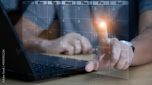 Time management concept. Businessman use laptop to manage time for effective work. Calendar on the virtual screen interface. Highlight appointment reminders and meeting agenda on the calendar.