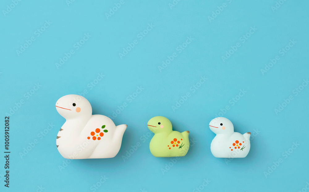 Japanese new year material. Zodiac Snake. Snake ornament on the light blue background. 日本のお正月素材。干支の巳(ヘビ)。水色背景上の巳の置物 Japanese new year material. Zodiac Snake. Snake ornament on the light blue background. 日本のお正月素材。干支の巳(ヘビ)。水色背景上の巳の置物