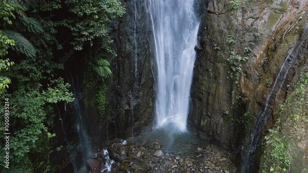 close-up drone video of a waterfall in the mountains, the drone moves backwards and the camera moves from bottom to top
close-up drone video of a waterfall in the mountains, the drone moves backwards and the camera moves from bottom to top