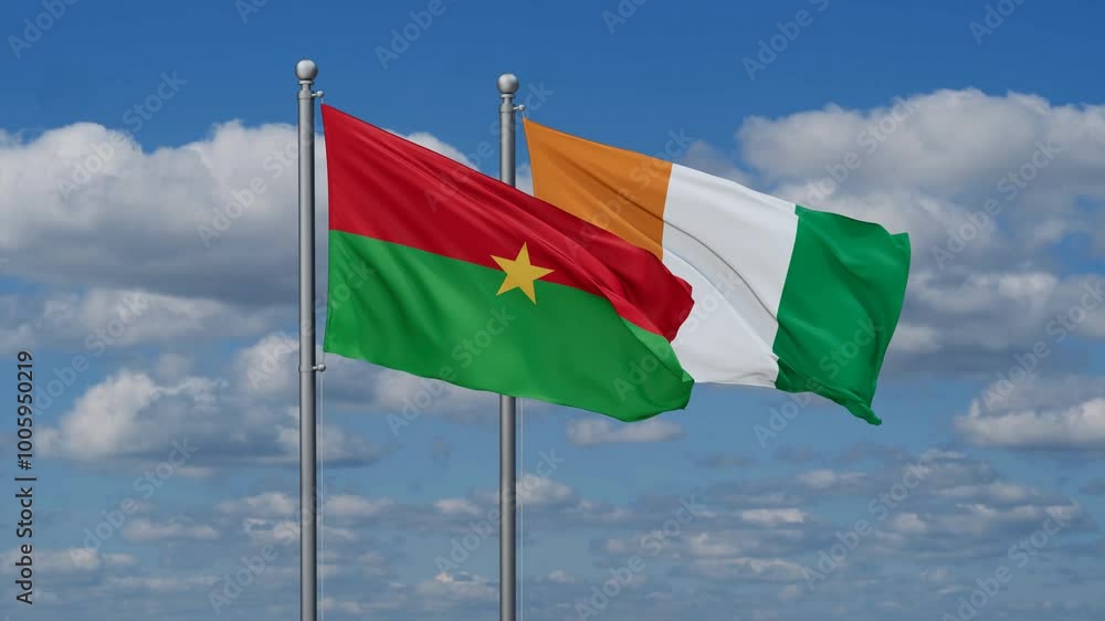 Ivory Coast or Cote d'Ivoire and Burkina Faso flags flying together, video concept of the relationship, two country cooperation concept Ivory Coast or Cote d'Ivoire and Burkina Faso flags flying together, video concept of the relationship, two country cooperation concept
