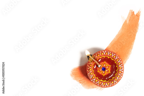 Hindu tradition Diwali diya oil lamps burning over paint stroke on white background.