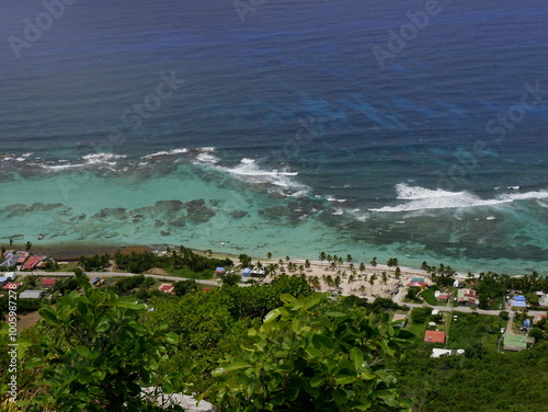 Aerial view of beach in la Désirade island in french west indies with coral reef stopping the waves and beach and coastline photo