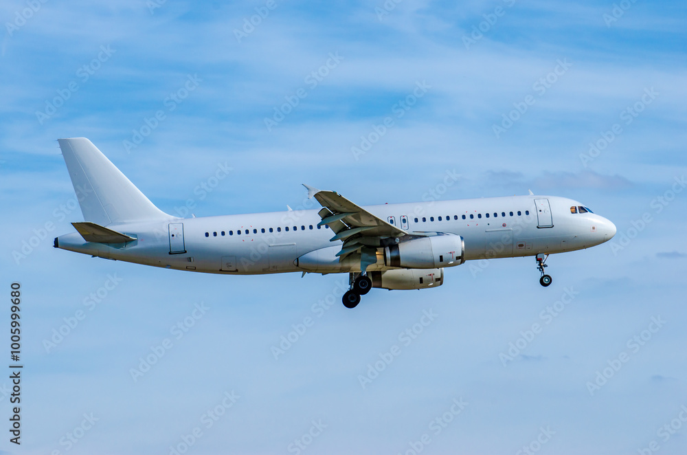 A white commercial airplane is arriving at the airport. A white commercial airplane is arriving at the airport.