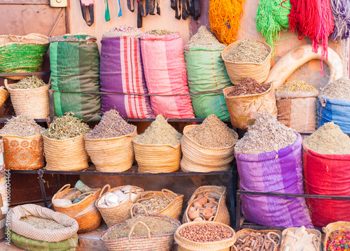 Market stall with sacks of herbs and spices at souk in Marrakesh, Morocco photo