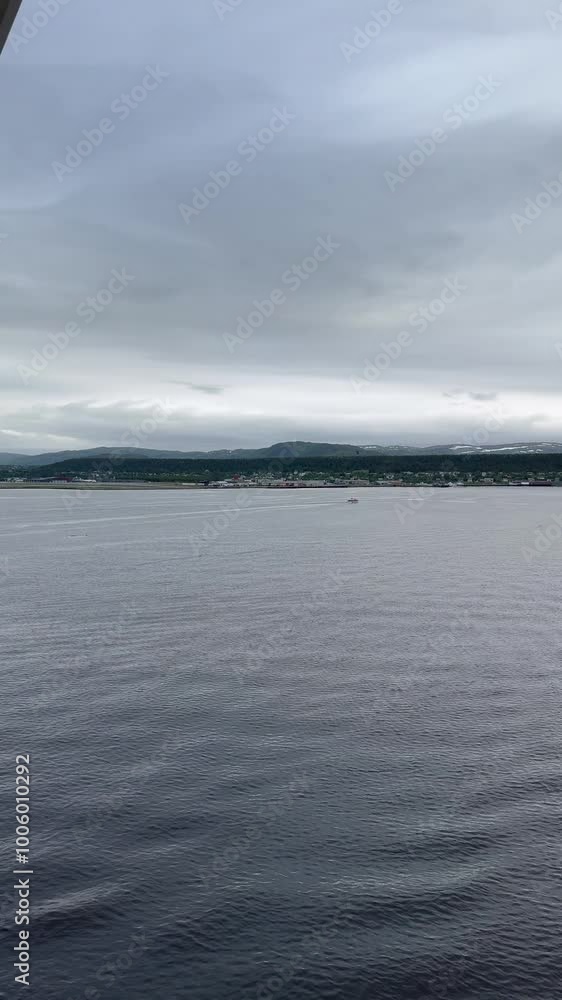 Alta Municipality, Finnmark, Norway - cloudy view from balcony tender cruise position onto town located on the southern end of Altafjorden by river Altaelva Alta Municipality, Finnmark, Norway - cloudy view from balcony tender cruise position onto town located on the southern end of Altafjorden by river Altaelva