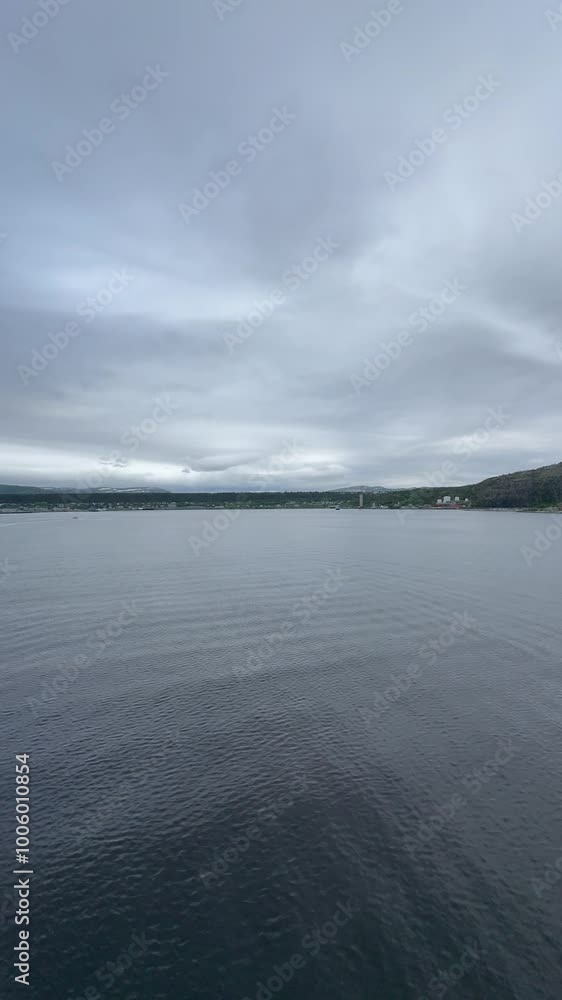 Alta Municipality, Finnmark, Norway - cloudy panorama view from balcony tender cruise position onto town located on the southern end of Altafjorden by river Altaelva