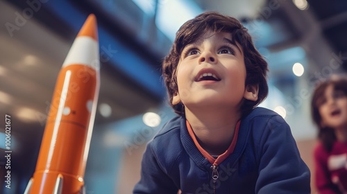 Young Boy Gazing Upward at a Toy Rocket, Dreaming of Space