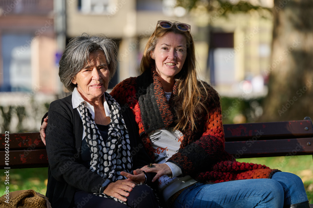 Embracing Generations: A Daughter's Love and Support for Her Senior Mother on a Sunny Day in the Park Embracing Generations: A Daughter's Love and Support for Her Senior Mother on a Sunny Day in the Park