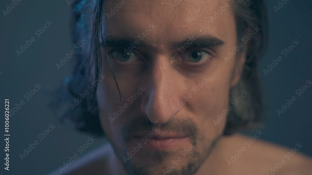 young handsome man without outerwear with long hair, brunette extra close up, large expressive eyes, long eyelashes, looks into the frame to the side, straightens his hair, slow motion young handsome man without outerwear with long hair, brunette extra close up, large expressive eyes, long eyelashes, looks into the frame to the side, straightens his hair, slow motion