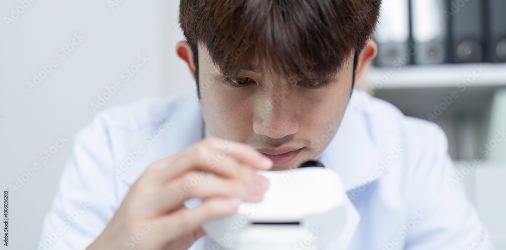 Scientist Focused on Examining Substance Under Microscope in Modern Laboratory Setting Scientist Focused on Examining Substance Under Microscope in Modern Laboratory Setting
